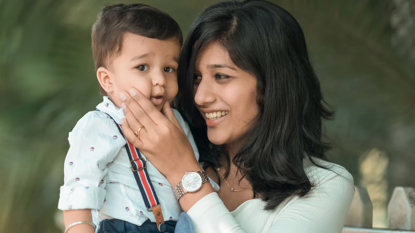 Mother smiling with her toddler outdoors